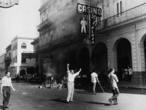 black and white of people looting and burning a casino circa 1948