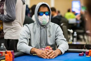 man playing poker with mask